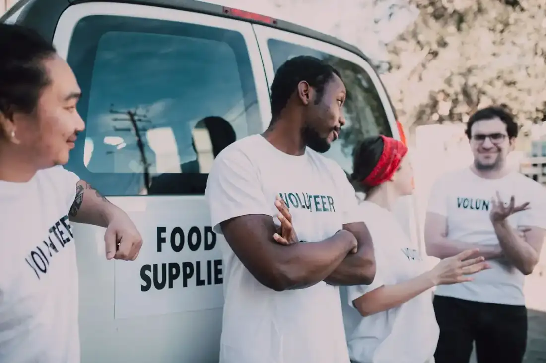 Volunteers unloading a food delivery van