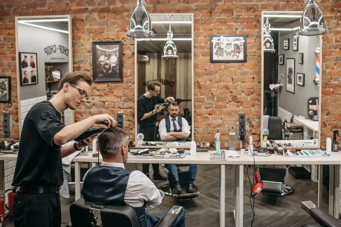 Inside the shop with chairs and mirrors