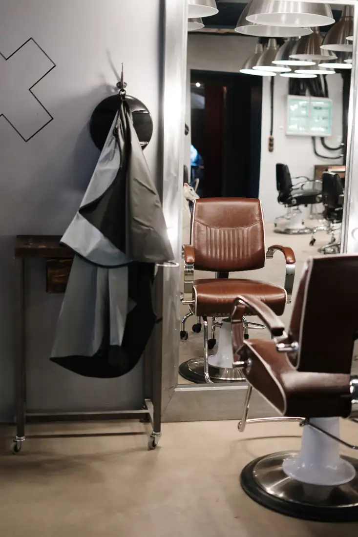 An empty barber chair with a cape
