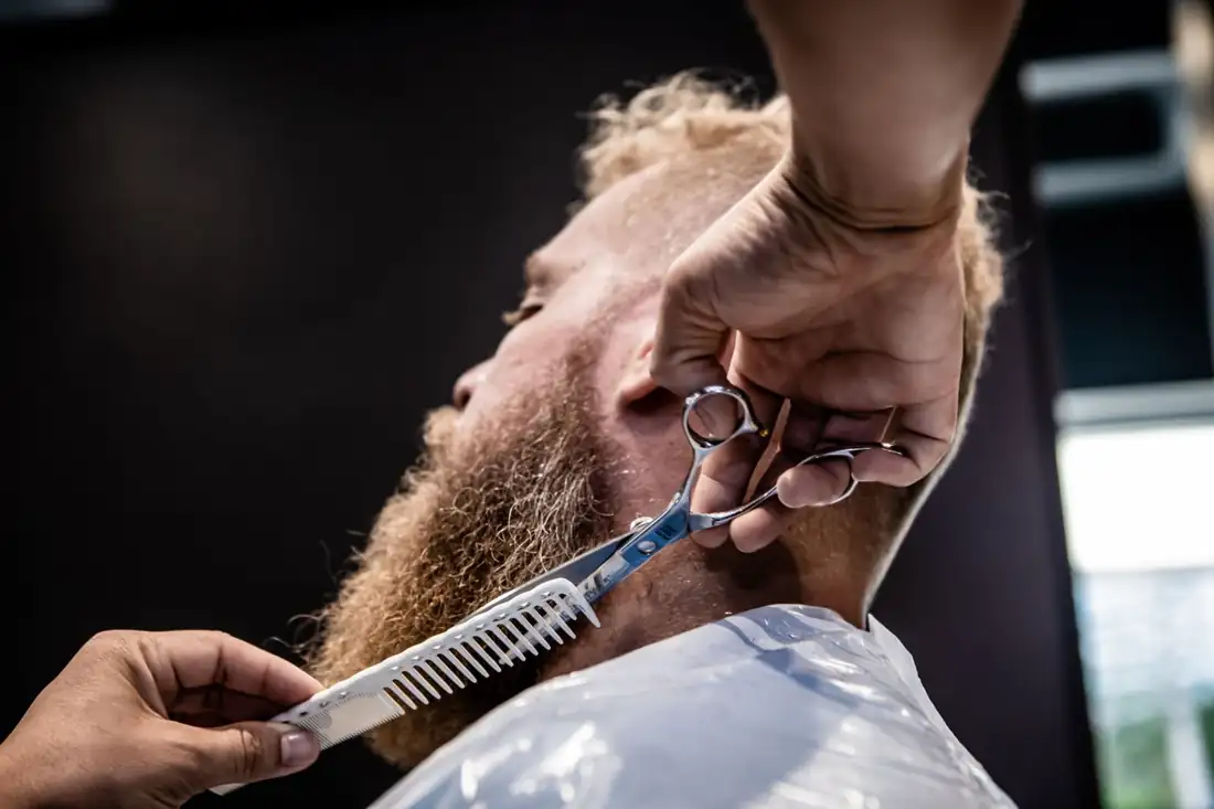 Sam trimming hair with scissors