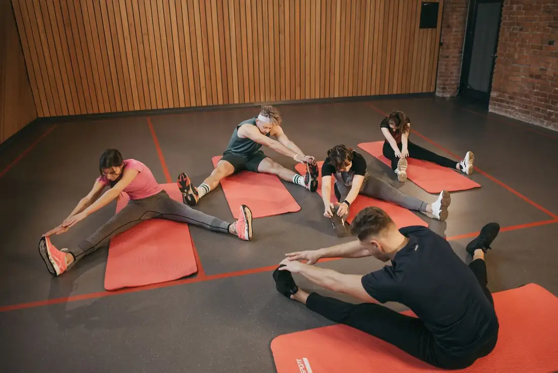 A group class working on mats