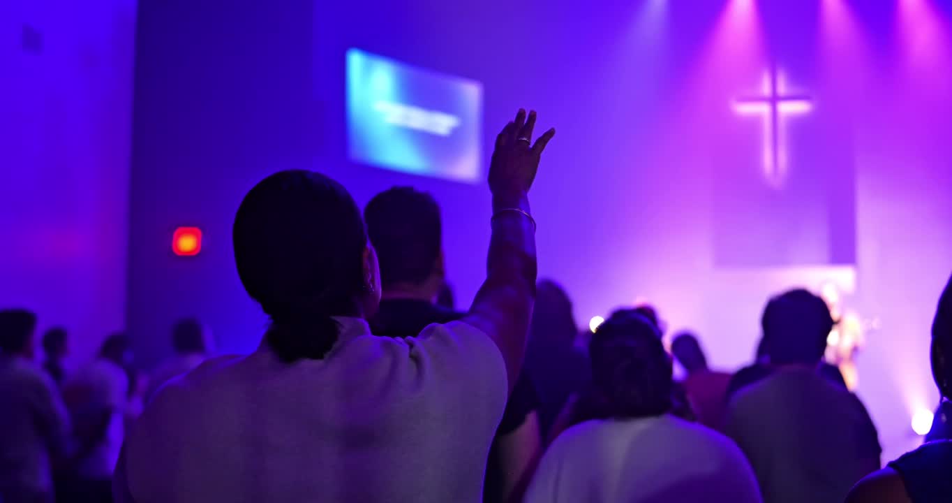 A worship gathering with warm stage lights