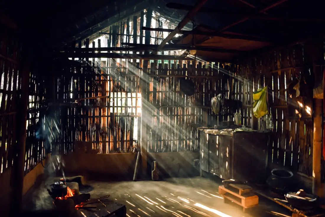 A loft interior with sunlight streaming through tall windows