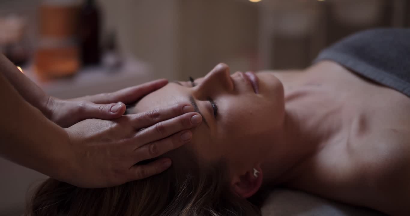 A therapist giving a gentle face massage